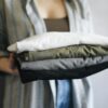 Folded stack of multi-color cotton t-shirts representing well-cared-for custom apparel