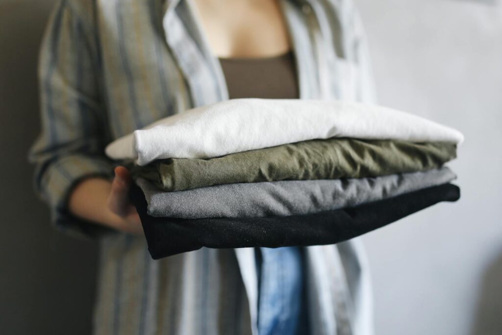 Folded stack of multi-color cotton t-shirts representing well-cared-for custom apparel